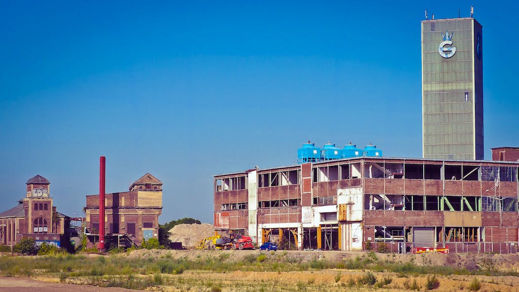 Blue Tanks on Top of Brown Building