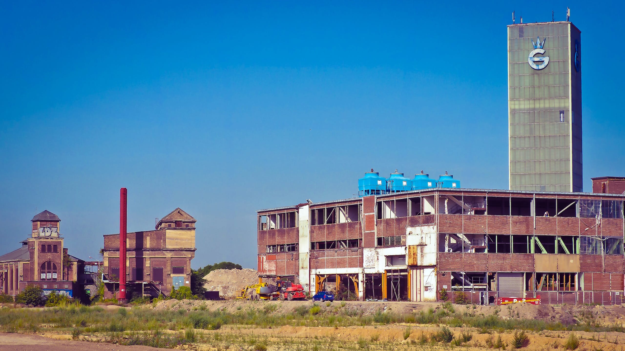 Blue Tanks on Top of Brown Building